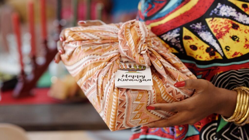 A person holds a Kwanzaa gift