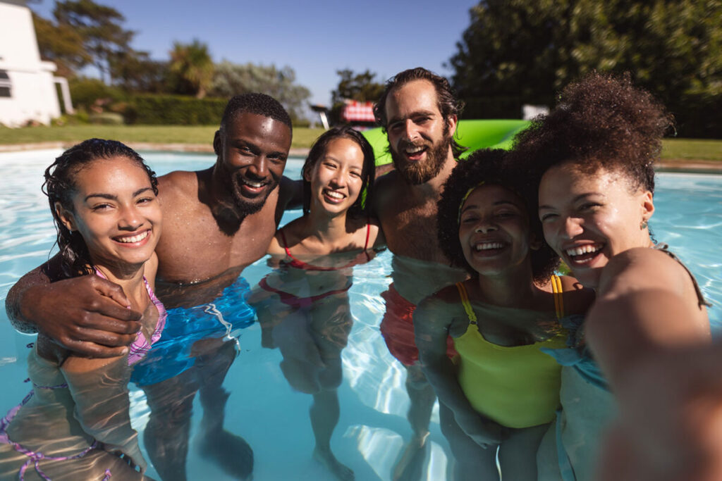 group in pool smiling and having fun